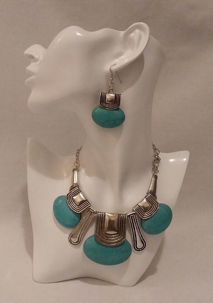 SOLD | Collar-style necklace and matching drop earrings set Oversized faux turquoise stones with textured, silver-tone geometric metalwork for a bohemian, tribal-inspired style.